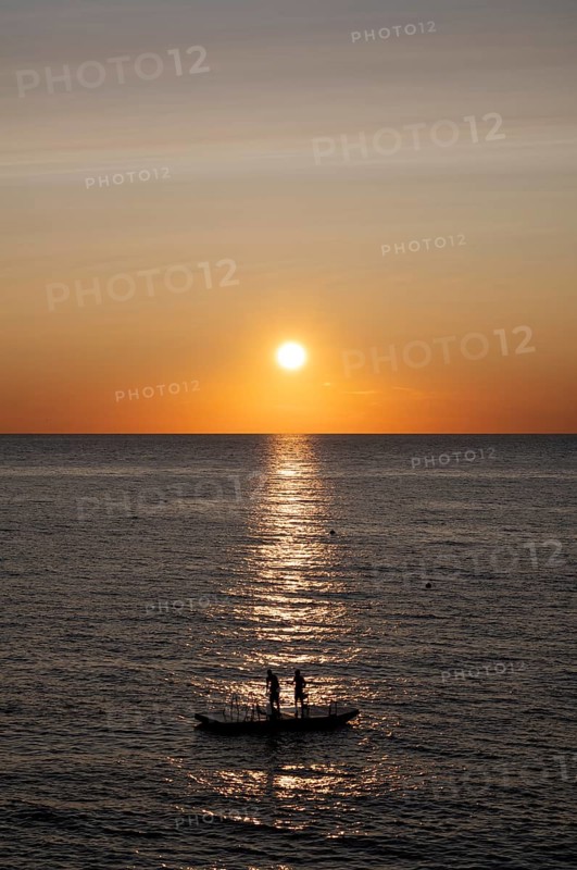 Children playing on bathing island, bathing raft, swimming island, Étretat, sea, sunset, evening mood, Normandy, Seine-Maritime, France
