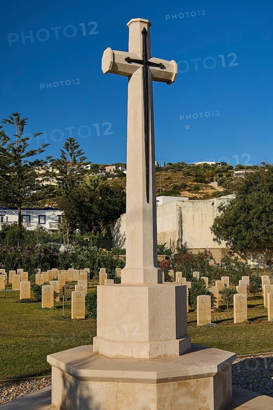 A high stone cross in a well-kept peaceful military cemetery under a clear blue sky, Military Cemetery, Commonwealth War Cemetery, Military Cemetery, WW2, 1939-1945, 179 graves, Alinda, Leros, Dodecanese, Greek Islands, Greece