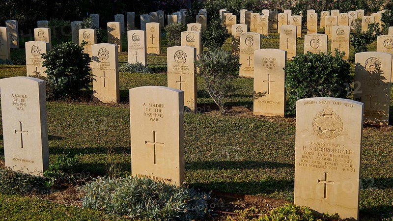 Rows of gravestones in a war cemetery surrounded by sunlight and green plants, Military Cemetery, Commonwealth War Cemetery, Military Cemetery, WW2, 1939-1945, 179 graves, Alinda, Leros, Dodecanese, Greek Islands, Greece