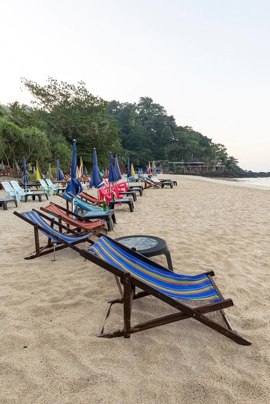 Abandoned deckchairs and parasol after sunset at Charlie Beach, Koh Mook Island, Andaman Sea, Thailand, Southeast Asia