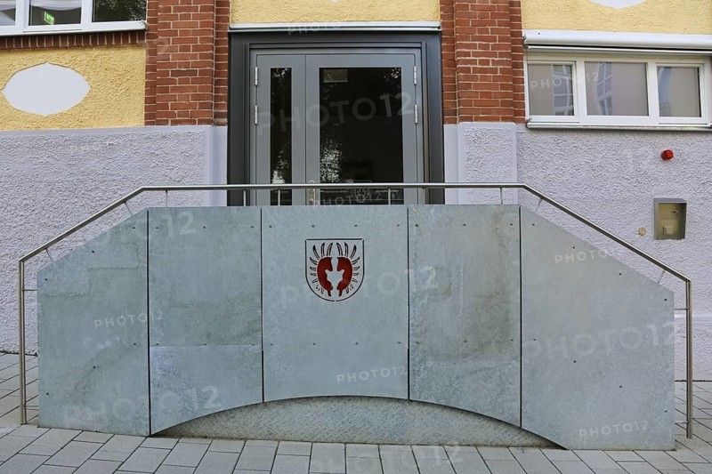 New town hall in the former Kindler corset factory, historical coat of arms of the Lords of Gomaringen, entrance, door, former Gotthold Kindler and Cie. corset factory, factory building, former textile industry, brick, building, Gomaringen, district of Tübingen, Baden-Württemberg, Germany