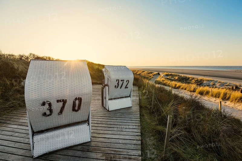 Beach chairs in the dunes and blue sky in winter, sunset, Spiekeroog, East Frisian Islands, Lower Saxony, Germany