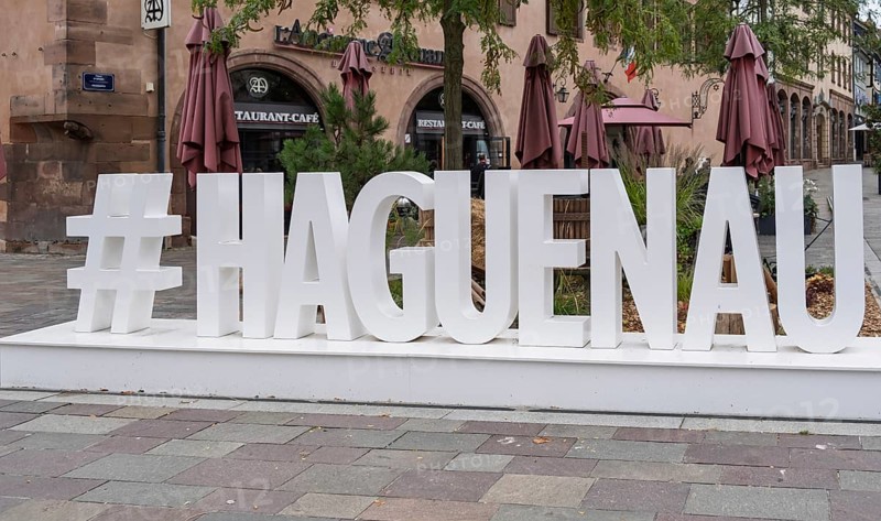 Large lettering in an urban setting with cafés in the background and autumnal flair, Haguenau, Bas-Rhin department, Alsace, France