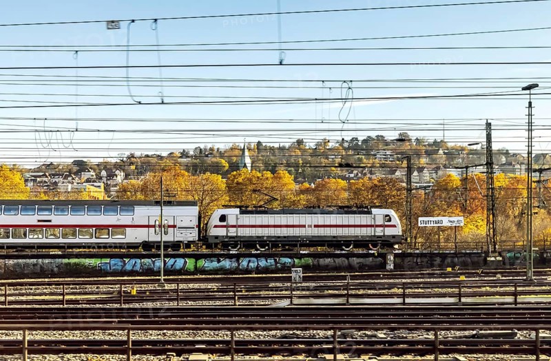 InterCity entering Stuttgart Central Station in autumn. Apron with station sign. Stuttgart, Baden-Württemberg, Germany