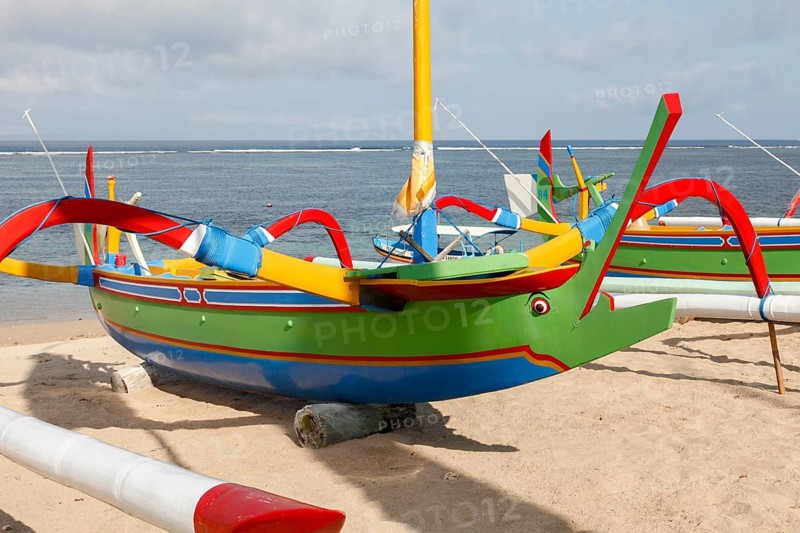 Colourfully painted fishing outriggers on Sanur beach, Bali, Indonesia