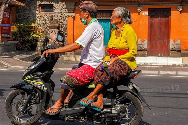 Motorcyclists wearing ceremonial clothes, Bali, Indonesia