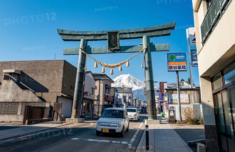 Cars drive through the city, Grand Torii Gate across a street, street scene, Mt. Fuji, Fujiyoshida, Yamanashi Prefecture, Japan