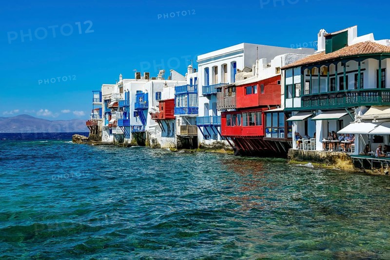 Mykonos, Cyclades, Greece - Little Venice is a picturesque neighborhood in Mykonos Town with colorful houses that stand right by the sea and are reminiscent of Venice. Little Venice is located on Alefkandra Bay next to the famous windmills of Mykonos. Mykonos is part of the Cyclades archipelago in the Aegean Sea
