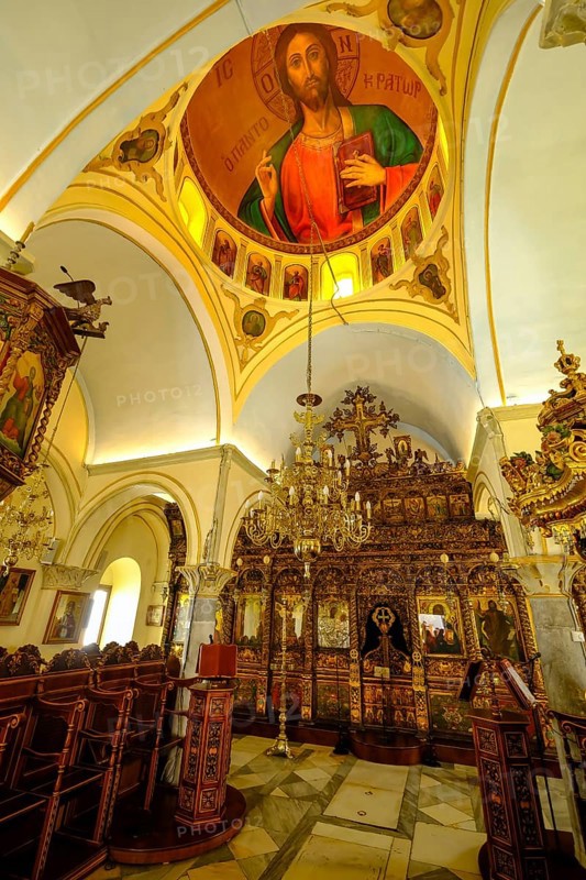 Ano Mera, Mykonos, Cyclades, Greece - The Panagia Tourliana monastery is the center of Ano Mera. Icons and lots of gold leaf inside the monastery. The men's convent from the 16th century on the village square in the interior of the island is now a tourist attraction much visited by tourists