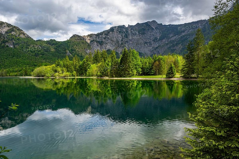 Landscape of Lake Offensee after rain when the sun comes through the clouds in spring, Salzkammergut, Austria