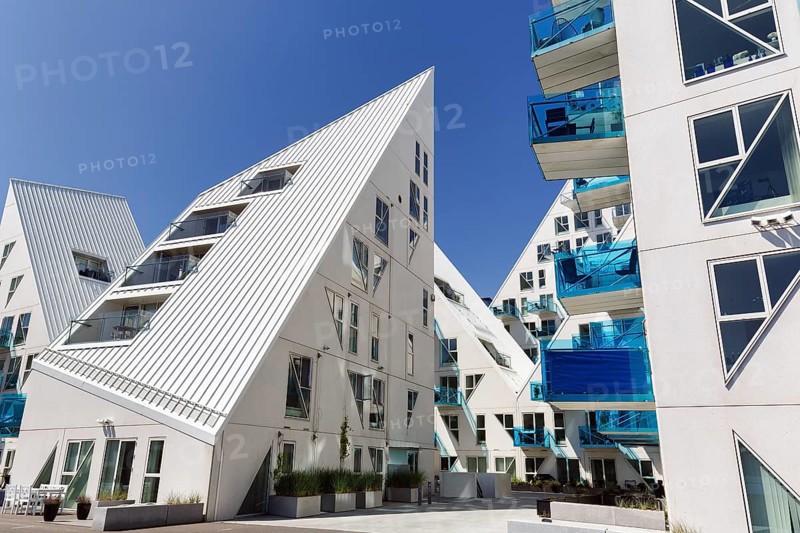 Distinctive white residential complex, turquoise balconies against blue sky, pyramid-shaped buildings, Isbjerget, iceberg, modern architecture in the harbor, Aarhus, Jutland, Denmark