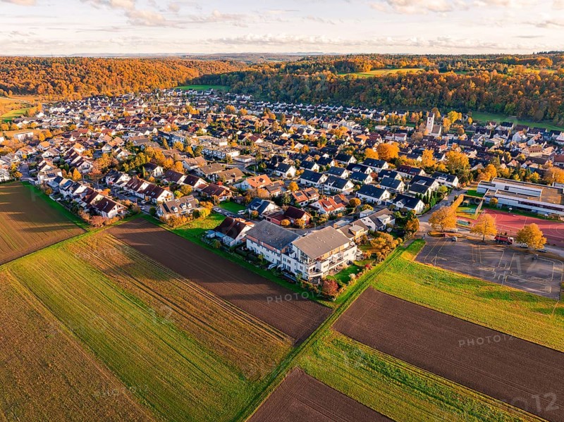 Large-scale view of a village bordering fields, in warm autumn light, Aidlingen, Böblingen district, Germany