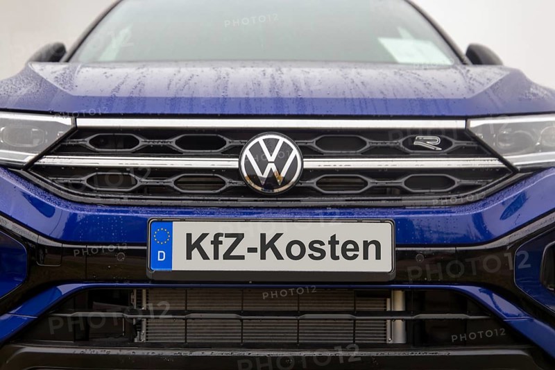 (photo montage) Close-up of a license plate with text Car costs