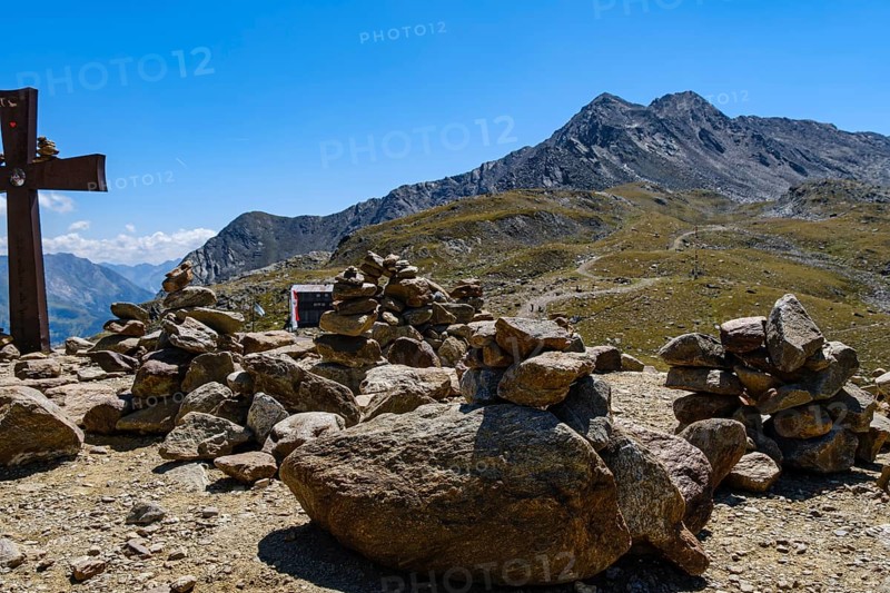 Stone men in front of an alpine landscape at the Timmelsjoch rest house on the border between Austria and Italy, above Hochgurgl, Gurgl, Sölden, Tyrol, Austria