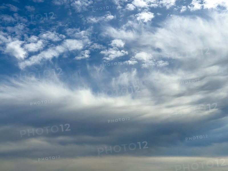 White clouds above Altocumulus floccus below Altostratus in front of above blue sky, international