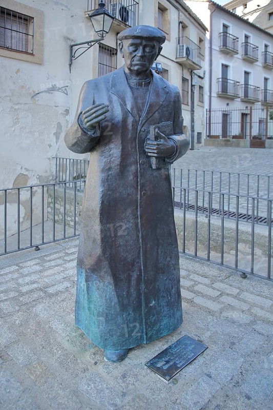 Sculpture and monument to priest Don Ramon Nunez Martin, statue man with book, life-size, bronze sculpture, modern art, Trujillo, Extremadura, Spain