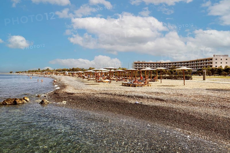 Parasol, sun lounger, sea, pebble beach, piled up with sand, people on the beach, Hotel Mitsis Ramira, Psalidi region, Kos island, Dodecanese Islands, Greece
