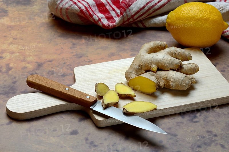 Ginger, ginger root cut with ginger slices on wooden boards