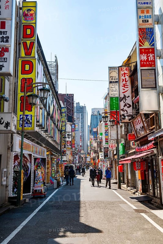 Street scene, lots of colorful signs of shops, restaurants and bars in a street, Shinjuku City, Tokyo, Japan