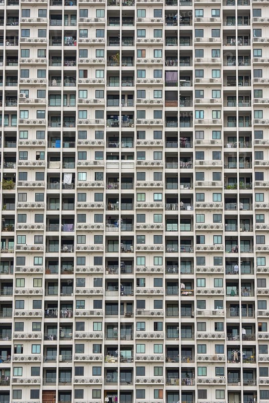 Exterior façade of a residential high-rise building of Condo U (a brand or series name of the Thai real estate developer Grand Unity Development Co., Ltd. (often abbreviated Grand U), Bangkok Yai district, the old town of Bangkok, Thailand