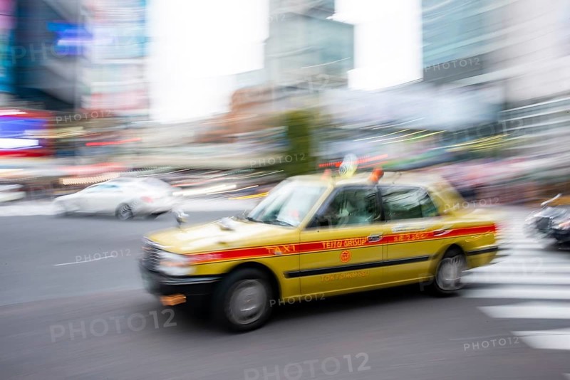 Elderly yellow taxi driving, motion blur, long exposure, Shubuya Crossing, Shibuya, Tokyo, Japan