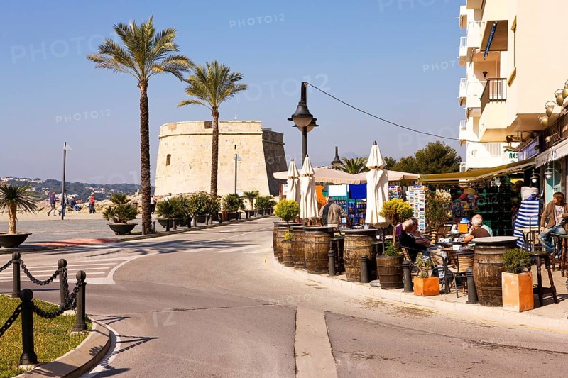 Beach promenade, shops, defensive defence tower, Moraira, former fishing village, pearl of the Costa Blanca, pedestrian zone at the harbor, palm trees, Valencia Spain Costa Blanca, Spain