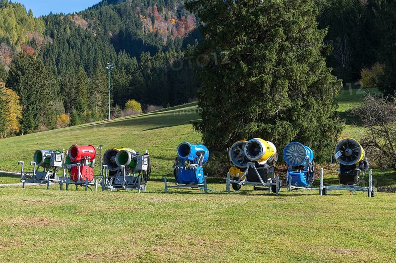 Different snow cannons on an extensive meadow in front of a forest in autumn, Schwangau near Füssen, Ostallgäu, Allgäu, Bavaria, Germany