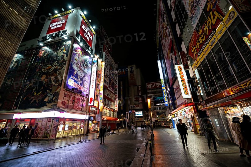 Street with illuminated shops and neon signs at night in Akihabara, Electric City, Tokyo, Japan