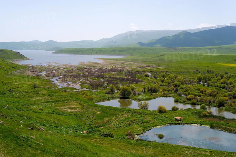 Wide landscape with wetlands and plants, surrounded by green hills and mountains, in the background the Spandaryan Reservoir, Spandarian, fed by the Vorotan River, Vorotan, Syunik Province, Armenia