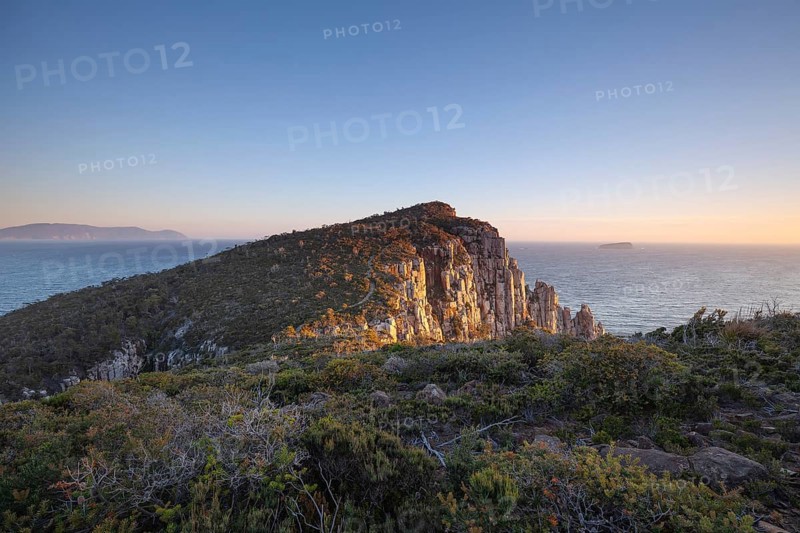 Sunrise hiking trail over the dramatic cliffs of Cape Hauy, Tasman Peninsula, Tasmania, Australia