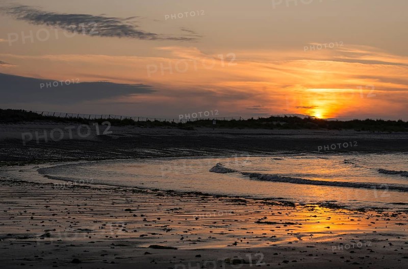 Sunset on a quiet beach with soft light on the waves, wet beach at low tide, dunes in the background, atmospheric, glowing, calm, warm atmosphere, reflecting light on water and beach, reflection, warm and cool tones, orange, yellow, gold, blue, grey, clouds, evening, shade, sandy beach, sand, shore, nobody, maritime, deserted, sea, soft waves, surf, swell, sea, swell, swell, sea, Bay, North Sea, Aade, Dune Island, Heligoland, Pinneberg District, Schleswig-Holstein, Germany