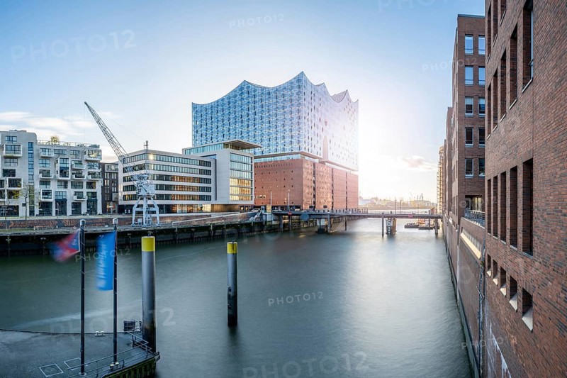 Long exposure of the Elbe Philharmonic Hall with Sandtorhafen and Mahatma Gandhi Bridge in light backlight, Hamburg, Germany