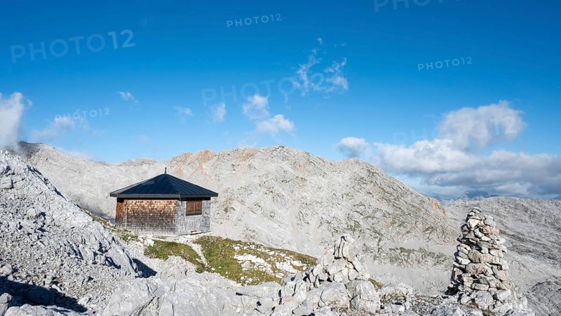 The Wildalmkirchl bivouac, a bivouac hut or bivouac box in the Steinernes Meer, with a large stone man, Berchtesgaden Alps, Austria