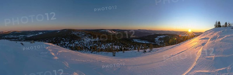 View from Mount Lusen over the hills of the bavarian forest at sunrise in winter, Bavaria, Germany