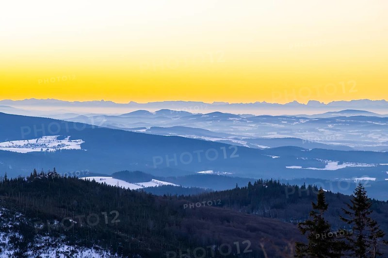 View from Mount Lusen over the hills of the bavarian forest at sunrise in winter, Bavaria, Germany