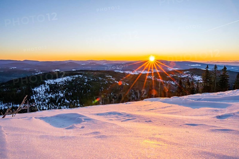 Sunrise over the hills of czech republic from Mount Lusen wth the view over the hills of the bavarian forest in winter, Bavaria, Germany