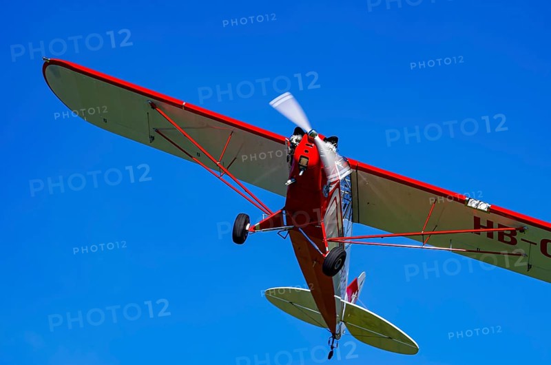 A Piper J-3C/L4 Cub light aircraft, HB-OBF registration, during a flight demonstration as part of an air show on Rossfeld in Metzingen-Glems, Baden-Württemberg, Germany, for editorial use only