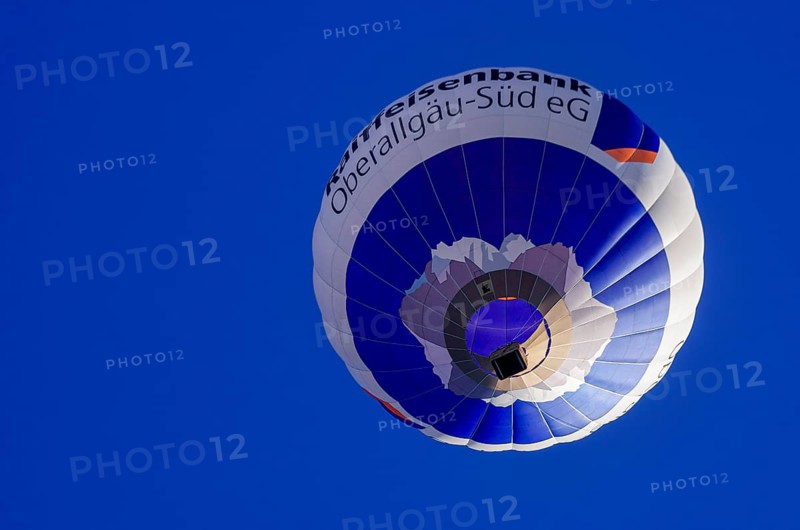 A hot air balloon, registration D-OASF, rises into the air as part of an air show at the Fliegerbergfest of the Rossfeld Luftsportverein in Metzingen-Glems, Baden-Württemberg, Germany, for editorial use only