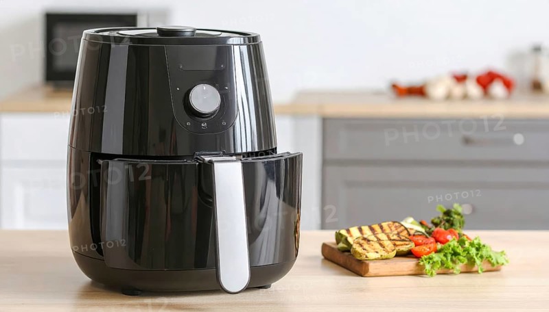 Air fryer with grilled vegetables, wooden table in the kitchen, healthy eating, healthy vegetarian lifestyle with fruits and vegetables, close up with blurred background, soft light, AI generated