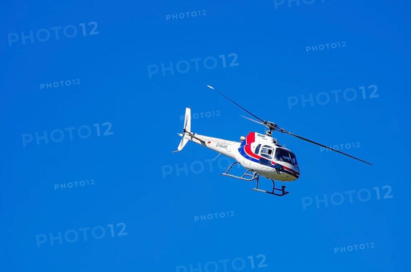 An Aerospatiale AS-350 BA Ecureuil helicopter, registration D-HAAN, from Meravo Air Company during a flight demonstration as part of an air show on Rossfeld in Metzingen-Glems, Baden-Württemberg, Germany, for editorial use only