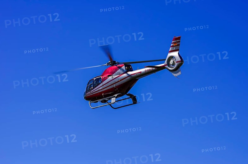 A Eurocopter EC 120B Colibri helicopter, D-HALX registration, during a flight demonstration as part of an air show on Rossfeld in Metzingen-Glems, Baden-Württemberg, Germany, for editorial use only
