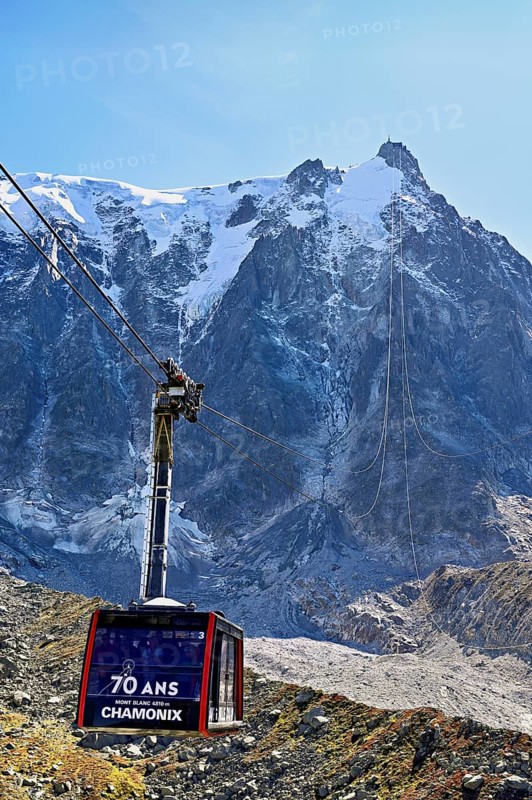 View of the arriving cable car from the Plan de l'Aiguille middle station, in the back the mountain station of the Aiguille du Midi, Chamonix-Mont-Blanc, Haute-Savoie, France