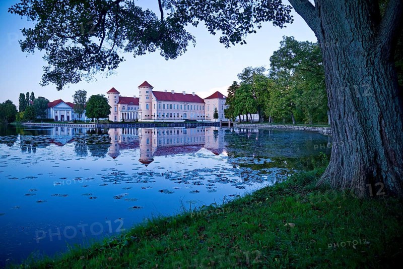 Rheinsberg Castle, lakeside with Lake Grienerick at night, prime example of Friederician Rococo, Brandenburg, Germany