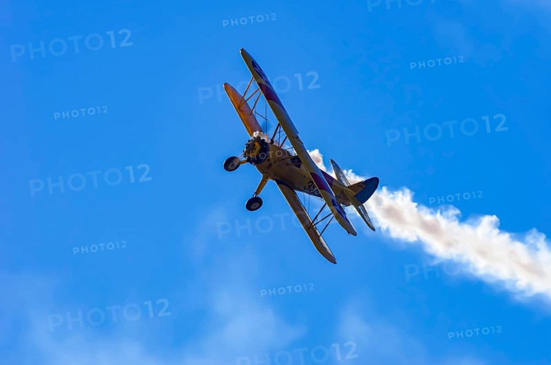 A Boeing PT-17 Stearman biplane, also Boeing Stearman Model 75, with the inscription 399 USNAVY N67193 during a flight demonstration as part of an air show on Rossfeld in Metzingen-Glems, Baden-Württemberg, Germany, for editorial use only