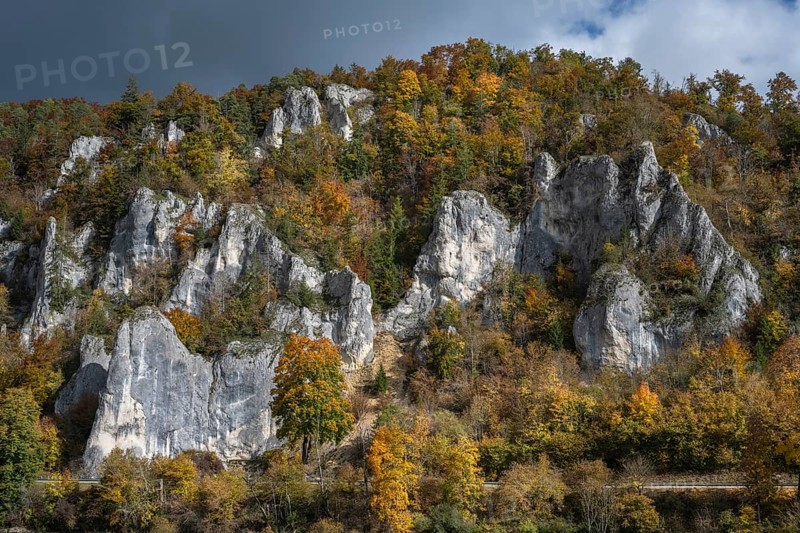 Distinctive Jurassic limestone cliffs in the upper Danube Valley, surrounded by autumn vegetation, on the right the raven rocks, Sigmaringen district, Baden-Württemberg, Germany