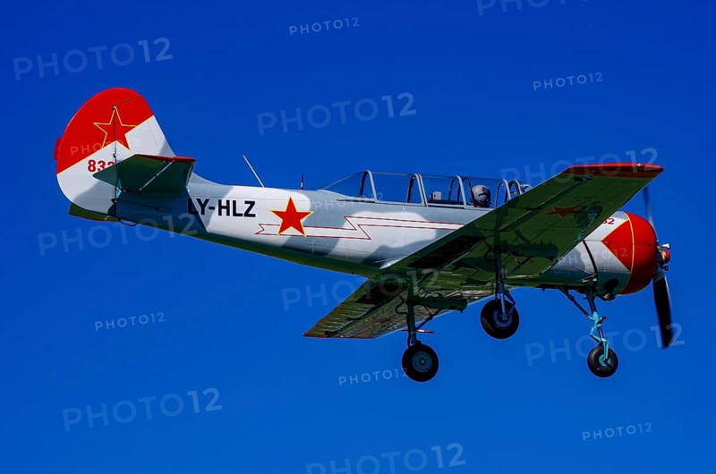 A Jakovlev Jak-52 with registration LY-HLZ during a flight demonstration as part of an air show on Rossfeld in Metzingen-Glems, Baden-Württemberg, Germany, for editorial use only