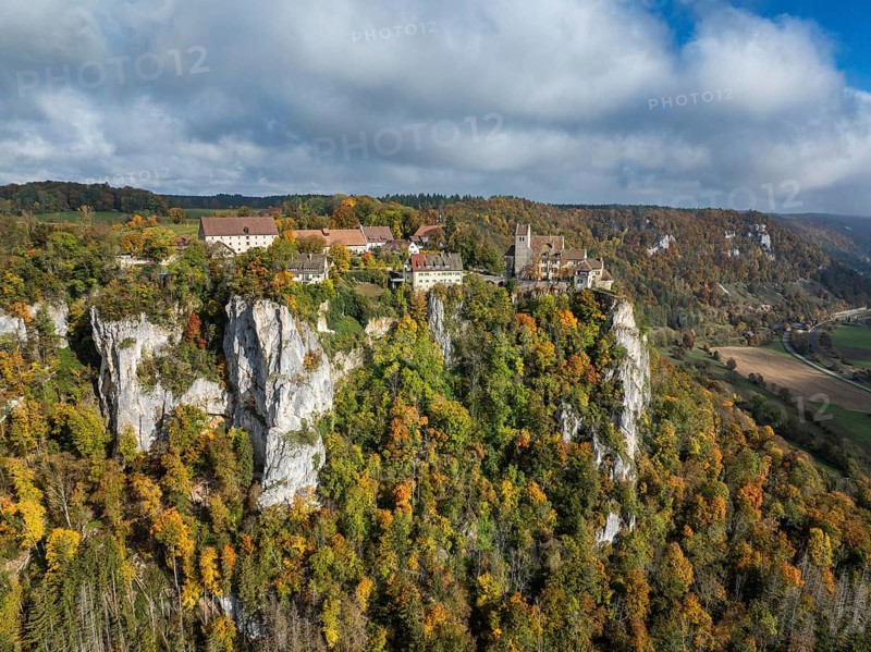 Aerial view of Werenwag Castle and former Werenwag Castle on a rocky spur in the Upper Danube Valley, surrounded by autumnal vegetation and clouds of fog, Sigmaringen district, Baden-Württemberg, Germany