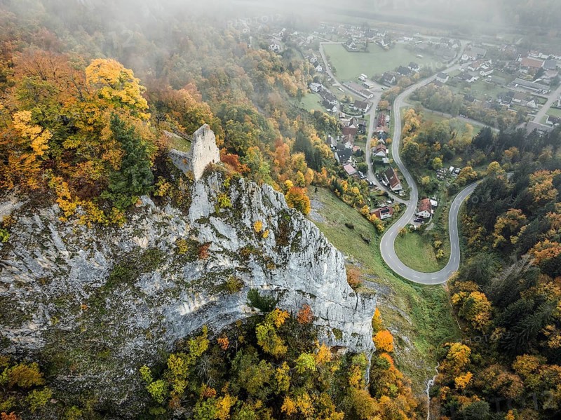 Aerial view of the viewpoint, shovels and Hausen Castle, also known as the Hausen ruins, surrounded by autumnal vegetation and clouds of fog, a ruin of a castle above the village of Hausen in the valley in the Upper Danube Valley, Beuron, Sigmaringen district, Baden-Württemberg, Germany