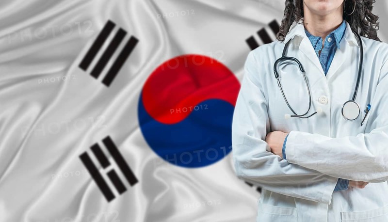 Medical professional on South Korea flag. Healthcare and wellness in South Korea, Concept