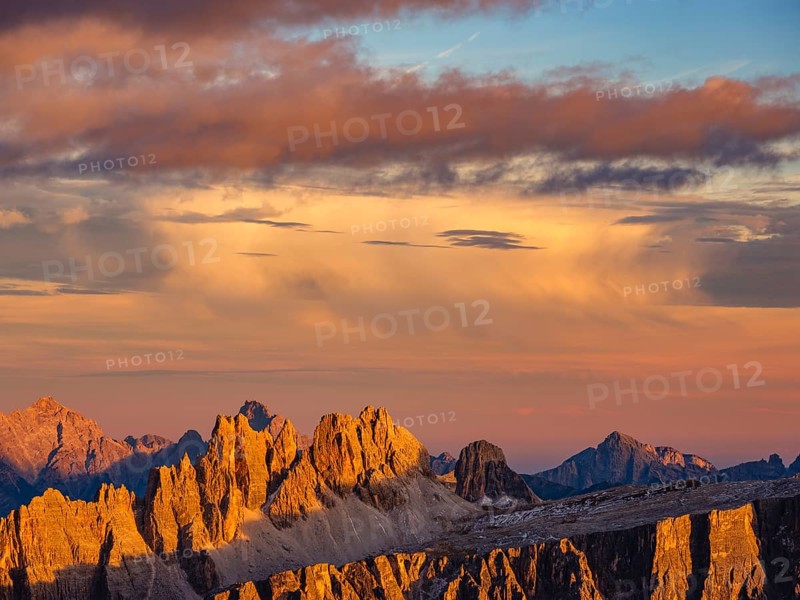 Alpine glow, rugged Dolomite peaks at sunset, colored clouds above, Dolomites, Alps, Belluno province, Veneto region, Veneto, Italy